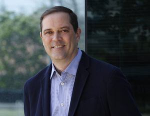 In this Friday, May 1, 2015 photo provided by Cisco Systems Inc., newly named CEO Chuck Robbins poses for a photo in San Jose, Calif. Current CEO John Chambers plans to step down after more than 20 years as CEO, the company announced Monday, May 4, 2015. Robbins will take over the post on July 26. (AP Photo/Cisco Systems Inc., Paul Sakuma)