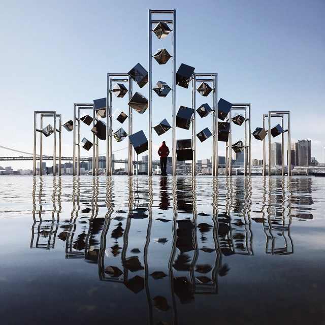 Man standing between floating cubes