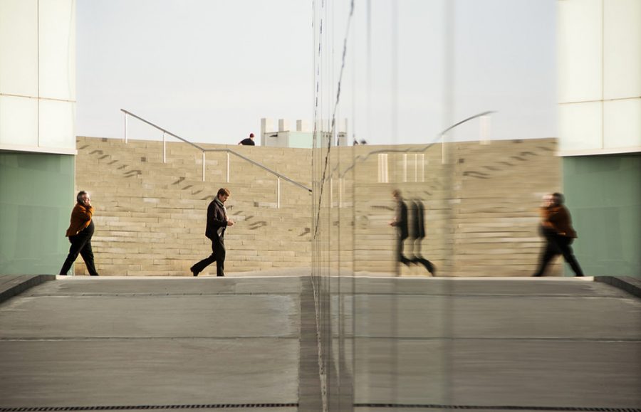 People walking toward mirror