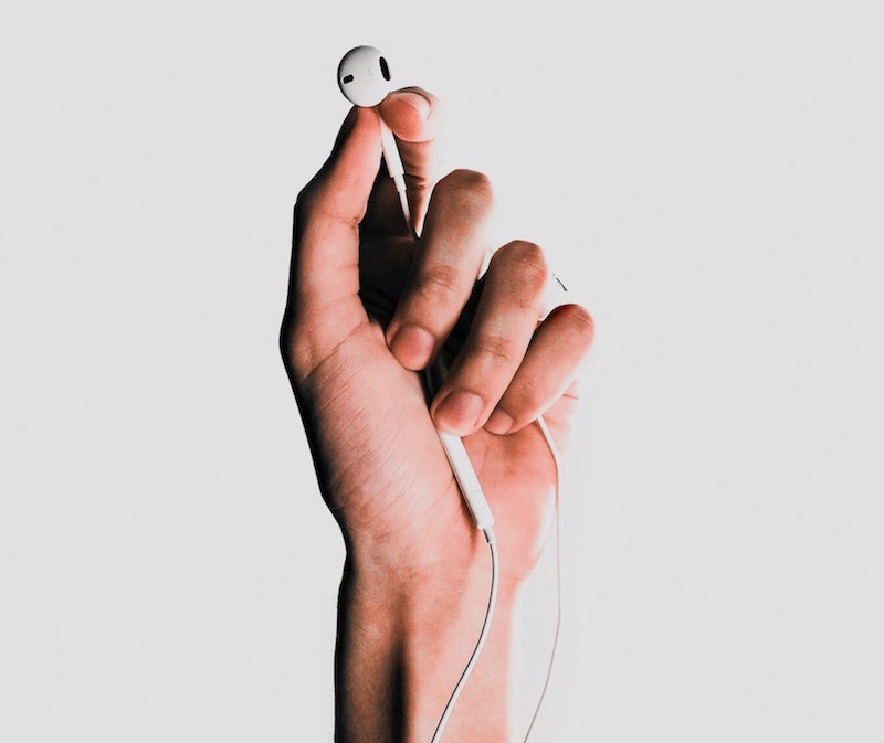 Hand holding earbuds