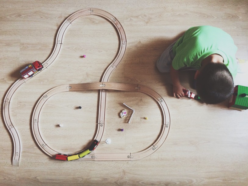 Boy playing with toy trains