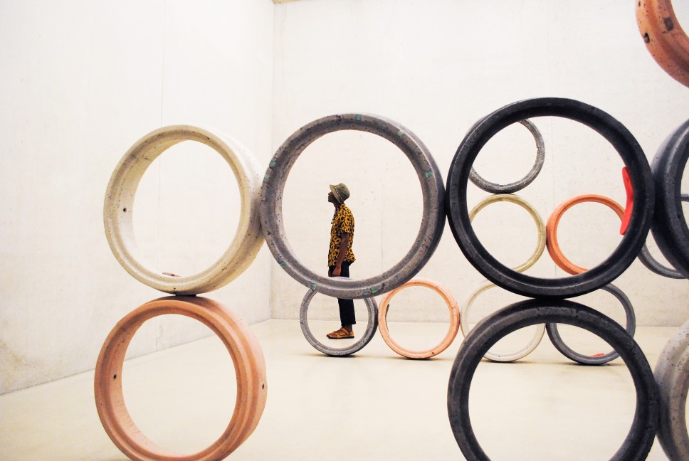 Man in art museum surrounded by circles
