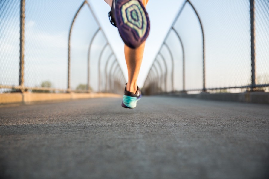 Person running on a bridge
