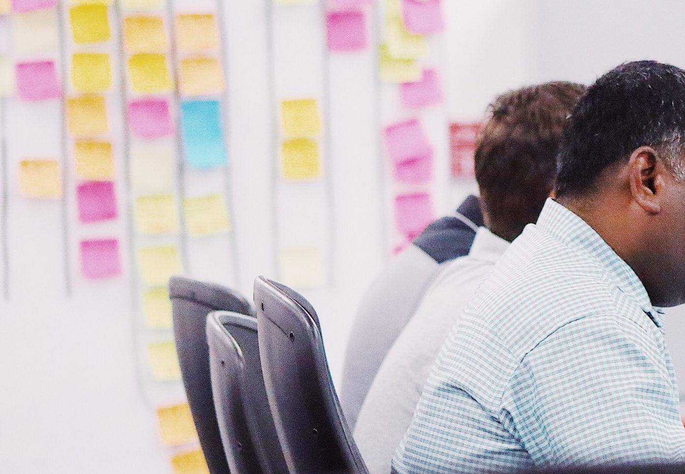 White board with post-its with people working