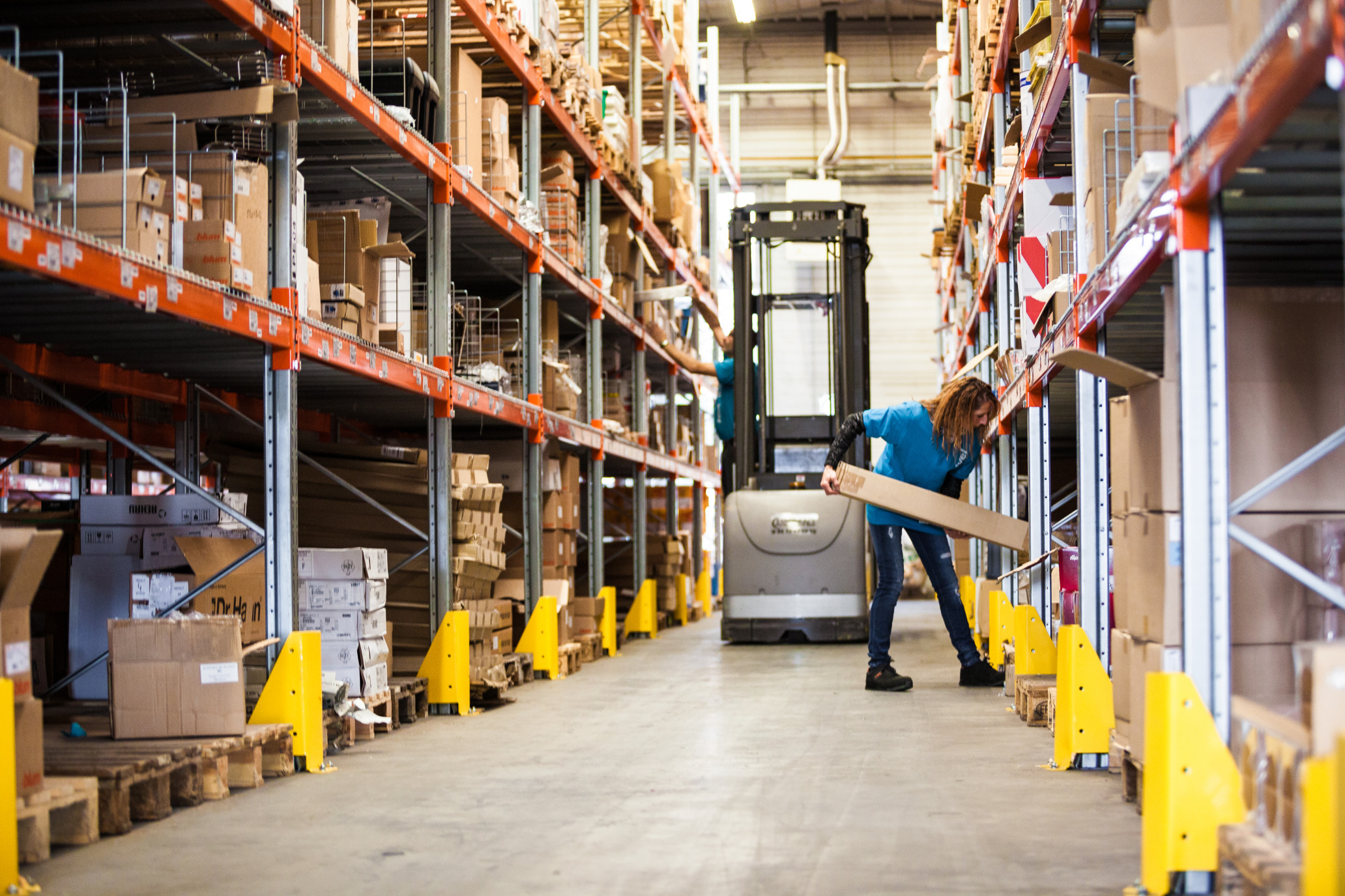 Woman stocking warehouse