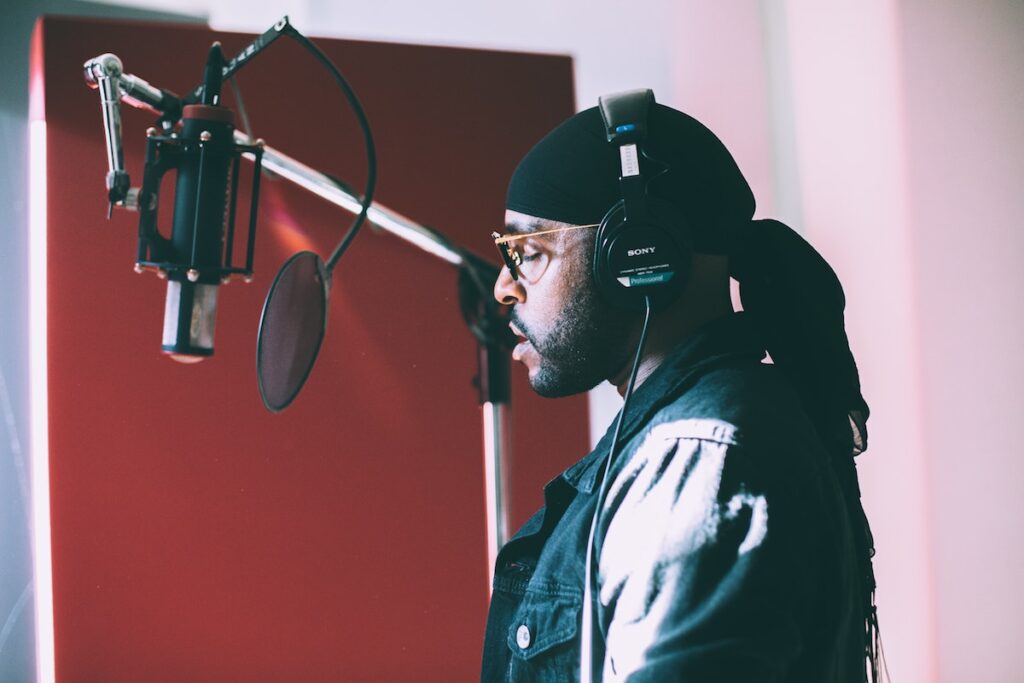 Verse Simmonds singing infront of condenser microphone